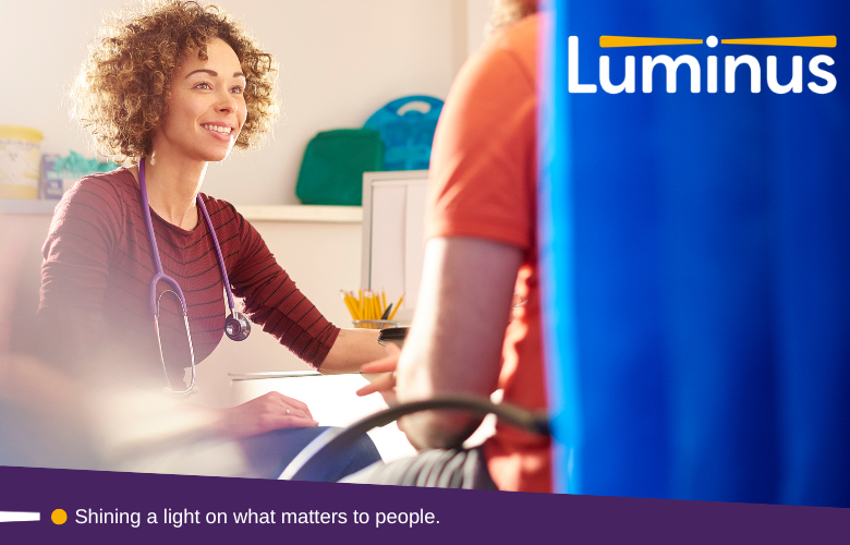 Photo of a GP talking to a patient. At the bottom is our strapline - Shining a light on what matters to people. In the top right of the photo is the Luminus logo.