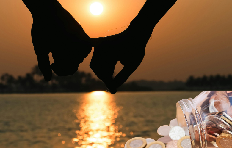 A photo of a sunset with a hand holding the little finger of another hand. Added to the foreground of the photo is a jar of coins spilling out.